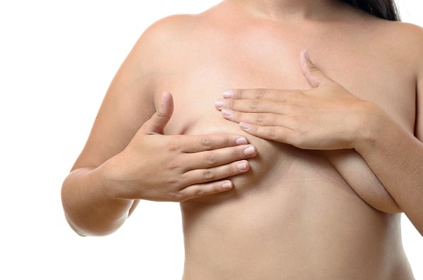 Woman Hiding Her Tubular Breasts With Her Hands