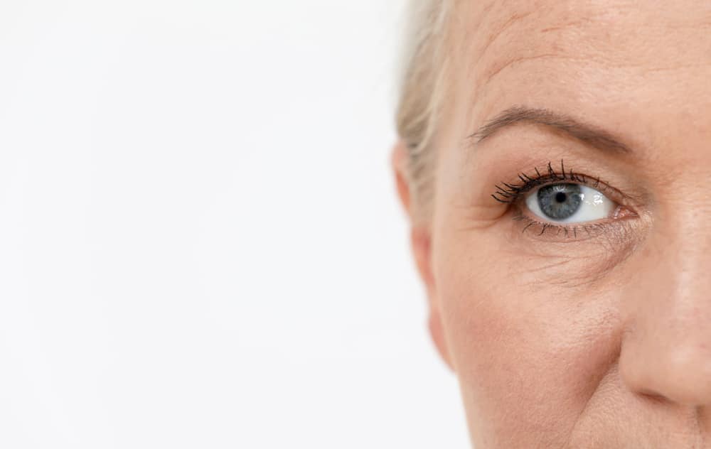 Close up of an older woman's eye with a lifted brow to make her expressions appear younger and more alert.