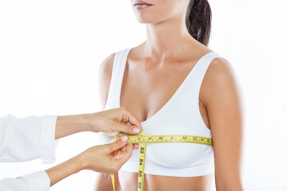 Woman having her large chest measured in preparation for a breast reduction.